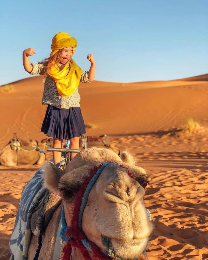 Sahara Majestic Luxury Camp Hotel Merzuga Kültér fotó A child riding a camel